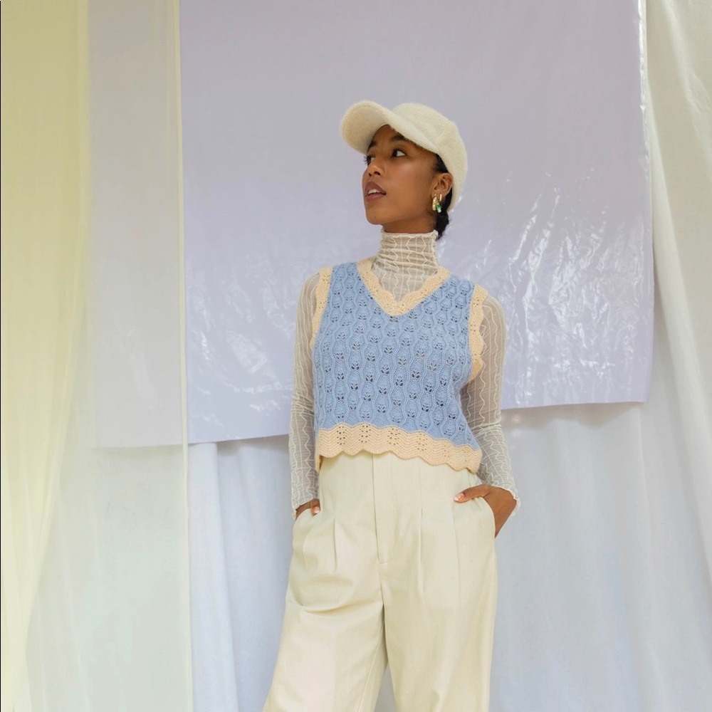 Find me now the Label baby blue and light taupe crocheted vest.